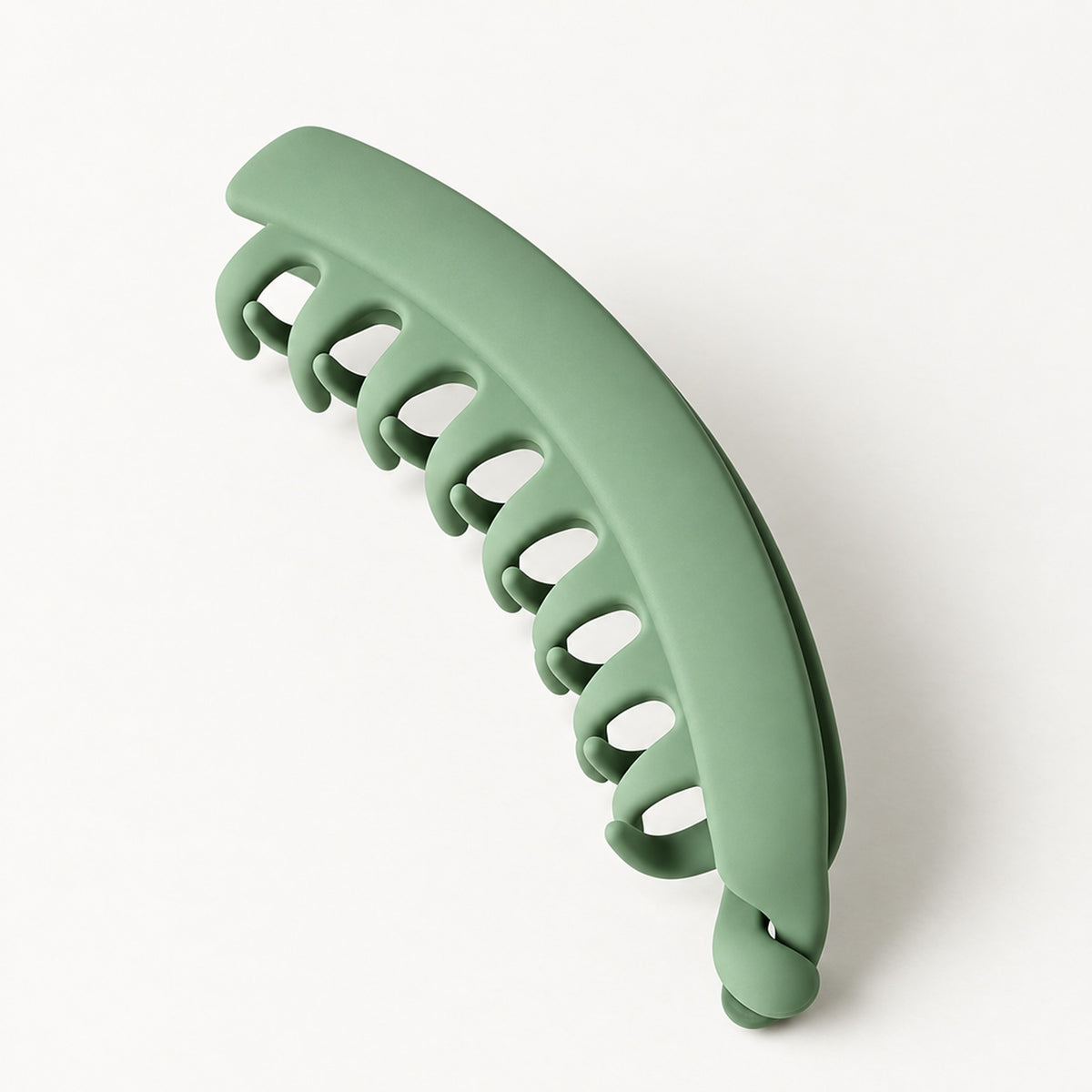 Grön bananklämma i matt finish sedd snett från sidan