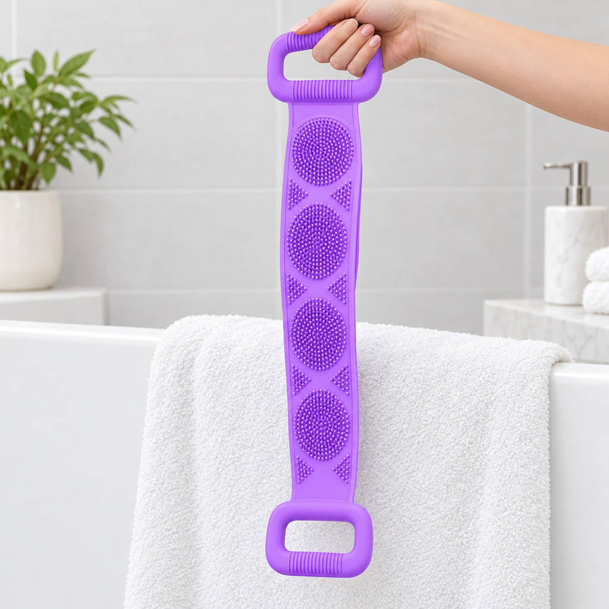 Hand håller i ryggskrubbens handtag över en vit handduk