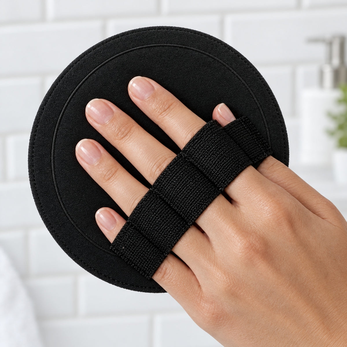 Hand med fingrarna genom det elastiska bandet på en svart rondell